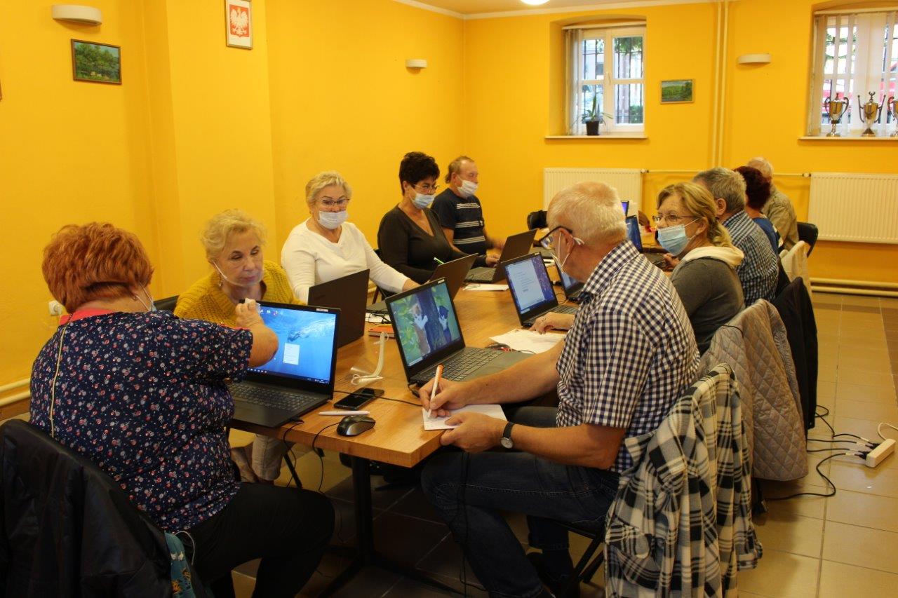 Zdjęcie przedstawia uczestników projektu przy laptopach.