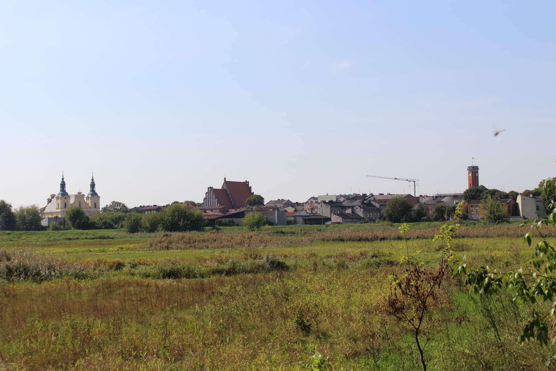 Zdjęcie przedstawia panorame miasta Koła od sr	rony rzeki Warty.